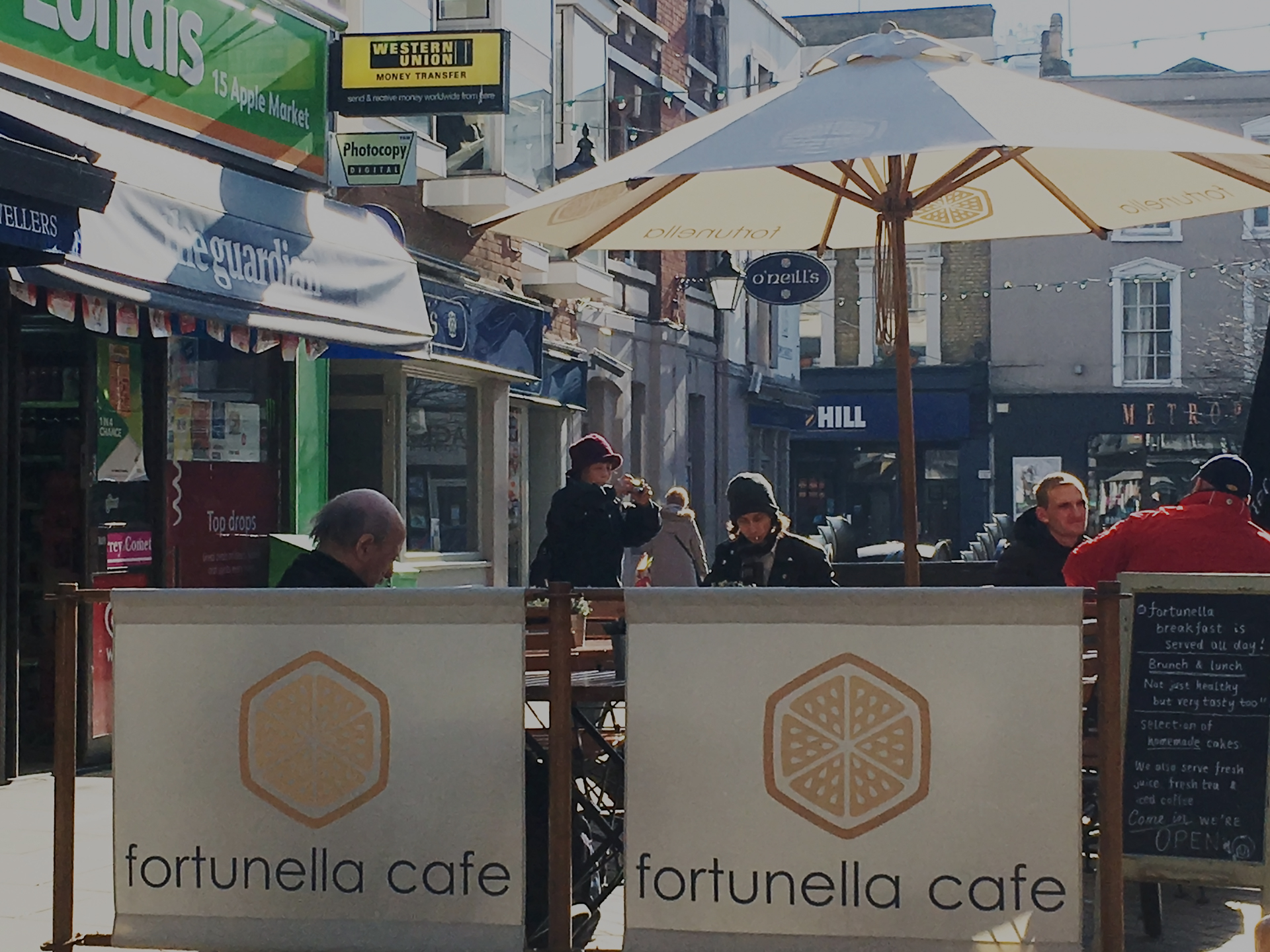 coffee shop with parasol and cafe barriers