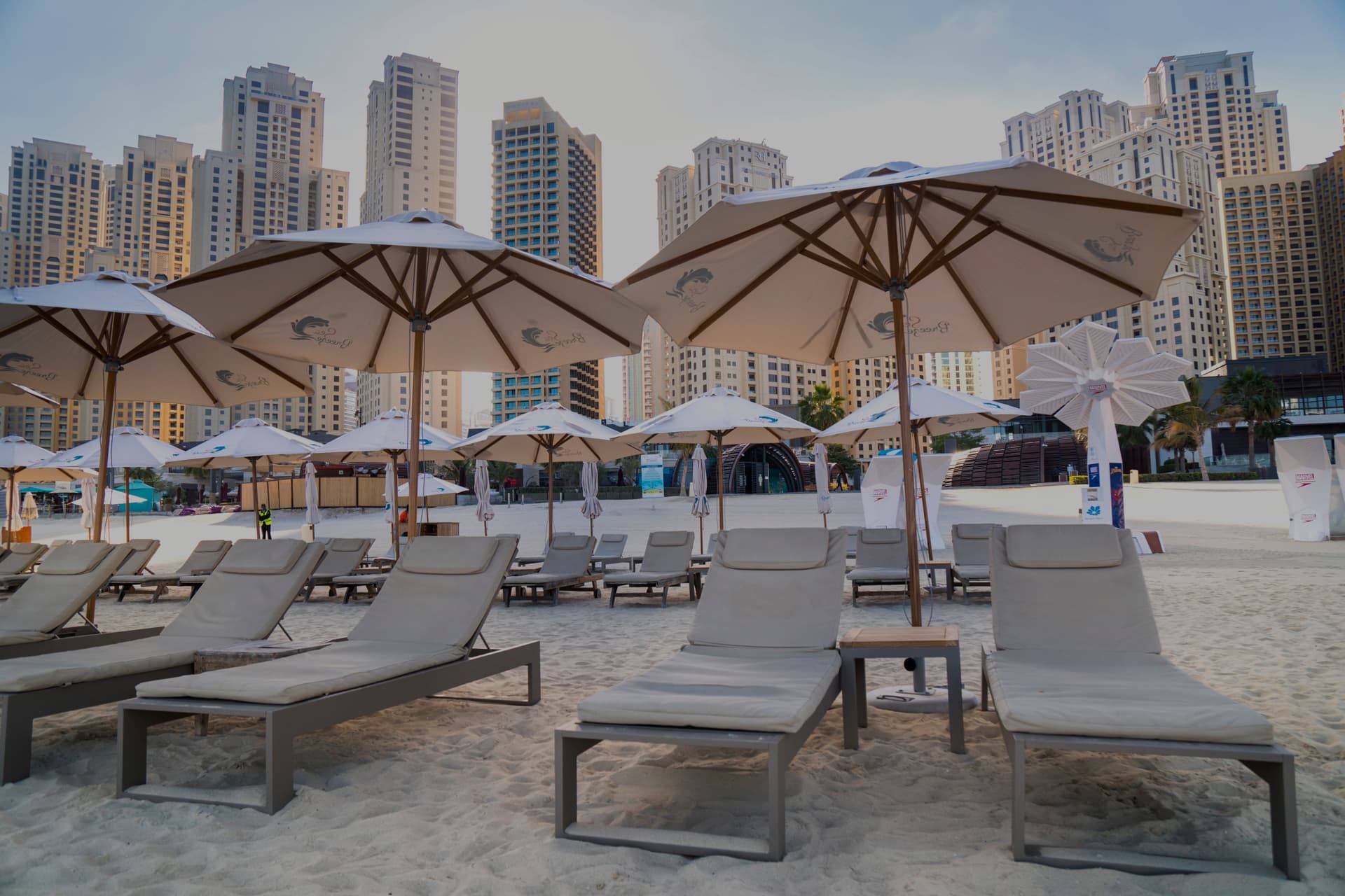 parasols on the beach next to hotels