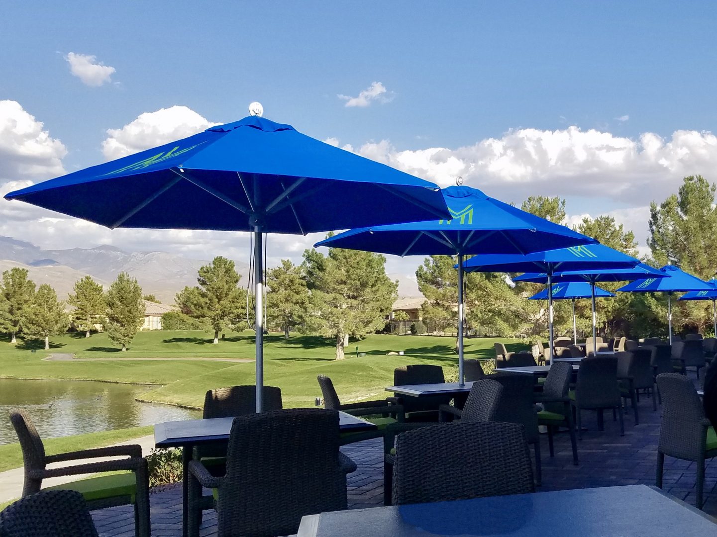 parasols on golf club, near a lake